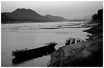 Dusk on the Mekong river framed by coconut trees. Luang Prabang, Laos (black and white)