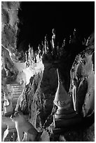 Buddhist statues left by pilgrims, lower Pak Ou cave. Laos ( black and white)