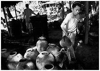 Making of the Lao Lao, strong local liquor in Ban Xang Hai village. Laos ( black and white)