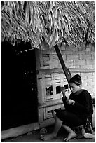 Woman of the Lao Huay tribe in front of her hut,  Ban Nam Sang village. Laos (black and white)