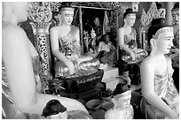 Surrounded by Buddha statues, Shwedagon Paya. Yangon, Myanmar ( black and white)