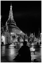 Praying at the wish-fullfilling place by night , Shwedagon Paya. Yangon, Myanmar ( black and white)