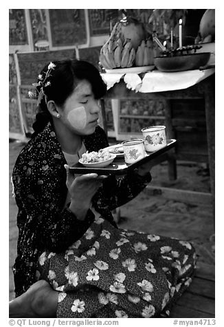 Burmese woman offering food. Bagan, Myanmar (black and white)