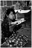 Burmese woman offering food. Bagan, Myanmar ( black and white)