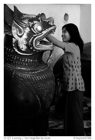 Rubbing an Angkor bronze statue at Mahamuni Paya. Mandalay, Myanmar (black and white)