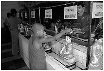 Novice offering Water at  Mahamuni Paya. Mandalay, Myanmar (black and white)