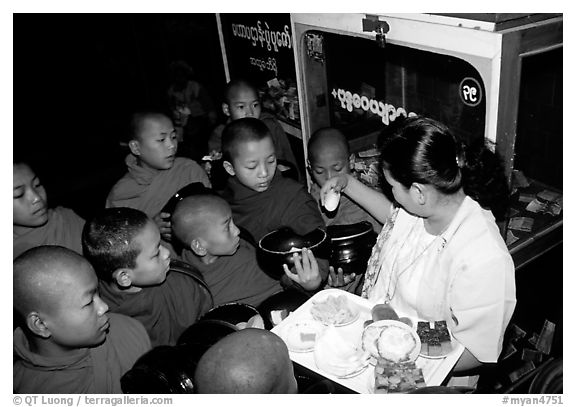 Novice during alm round at Mahamuni Paya. Mandalay, Myanmar