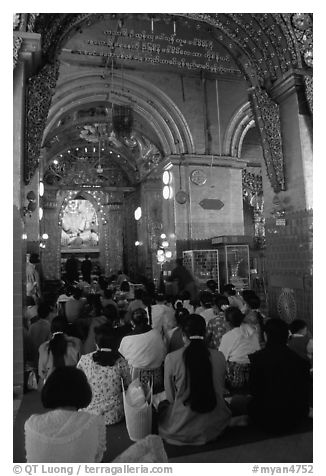 Woman praying at the venerated Mahamuni image. Mandalay, Myanmar