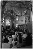 Woman praying at the venerated Mahamuni image. Mandalay, Myanmar ( black and white)