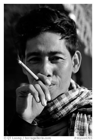 Man enjoying a cheerot (burmese cigar). Myanmar (black and white)