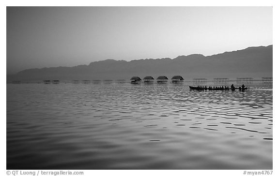 Long boat,  stilts huts, and mountains, sunrise. Inle Lake, Myanmar