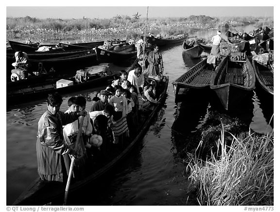 Children commuting to school on small boat. Inle Lake, Myanmar