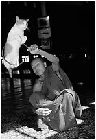 Jumping cat and monk. Inle Lake, Myanmar ( black and white)