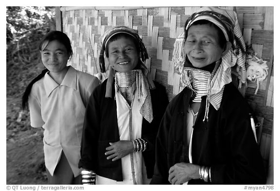 Three generations of Padaung women	along hut. Shan state, Myanmar (black and white)