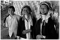 Three generations of Padaung women	along hut. Shan state, Myanmar ( black and white)