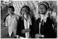 Three generations of Padaung women	along hut. Shan state, Myanmar (black and white)