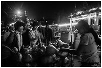 Customers waiting for coconuts to be cut on the street. Yangon, Myanmar ( black and white)