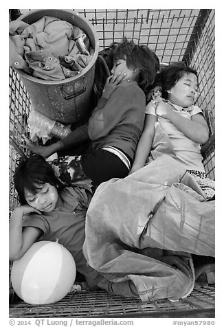 Children sleeping in street cleaning cart. Yangon, Myanmar (black and white)