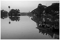 Families on shore of Kandawkyi Lake at sunset. Yangon, Myanmar ( black and white)