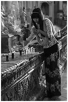 Woman lighting candles, Shwedagon Pagoda. Yangon, Myanmar ( black and white)