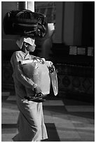 Nun carrying lots of luggage, Shwedagon Pagoda. Yangon, Myanmar ( black and white)