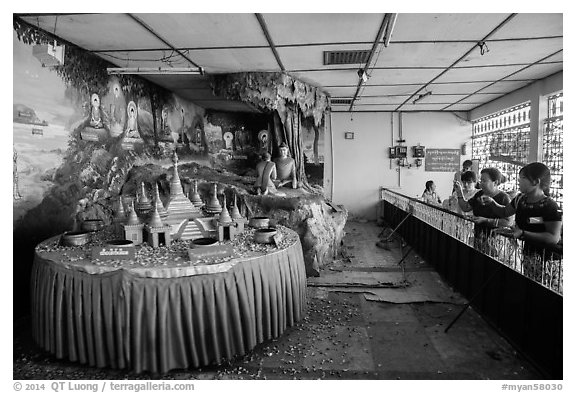 Visitors play arcade game, Botataung Pagoda. Yangon, Myanmar (black and white)