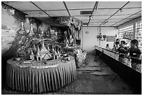 Visitors play arcade game, Botataung Pagoda. Yangon, Myanmar ( black and white)