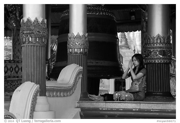 Woman praying next to bell, Shwedagon Pagoda. Yangon, Myanmar (black and white)