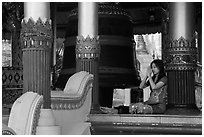 Woman praying next to bell, Shwedagon Pagoda. Yangon, Myanmar ( black and white)