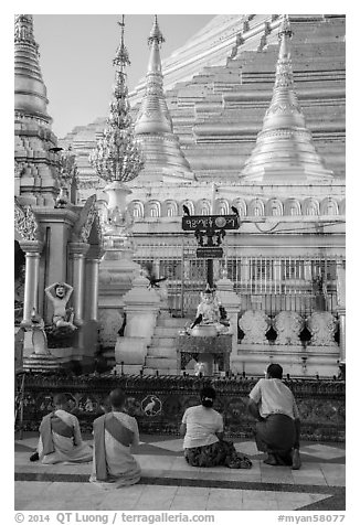 Nuns and couple worshipping at planetary station, Shwedagon Pagoda. Yangon, Myanmar (black and white)