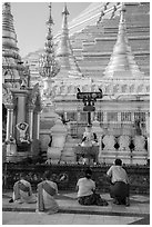 Nuns and couple worshipping at planetary station, Shwedagon Pagoda. Yangon, Myanmar ( black and white)