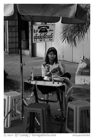 Phone booth operator. Yangon, Myanmar (black and white)