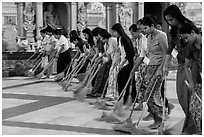 Women lining up to sweep the platform, Shwedagon Pagoda. Yangon, Myanmar ( black and white)