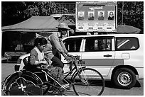Trishaw, taxi, and billboard promoting monks. Yangon, Myanmar ( black and white)