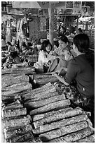 Women selling wood ground to make thanaka. Bagan, Myanmar ( black and white)