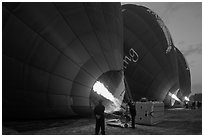 Crew inflates hot air balloons with propane burners. Bagan, Myanmar ( black and white)