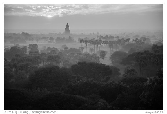 Bagan tower and sun above morning mist. Bagan, Myanmar (black and white)