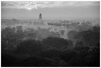 Bagan tower and sun above morning mist. Bagan, Myanmar ( black and white)