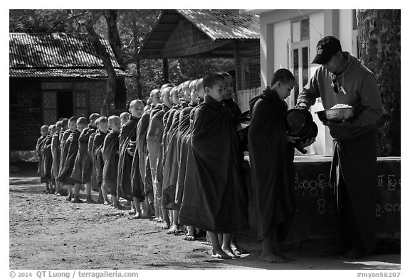 Buddhist novices lining up to receive rice for lunch, Nyaung U. Bagan, Myanmar (black and white)