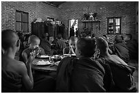 Buddhist novices pray at table before eating lunch, Nyaung U. Bagan, Myanmar ( black and white)
