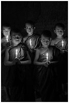 Group of buddhist novices holding candles. Bagan, Myanmar ( black and white)