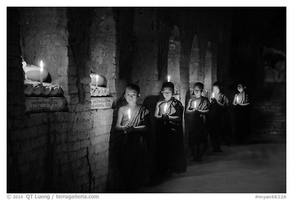 Buddhist novices in temple illuminated with candles. Bagan, Myanmar (black and white)