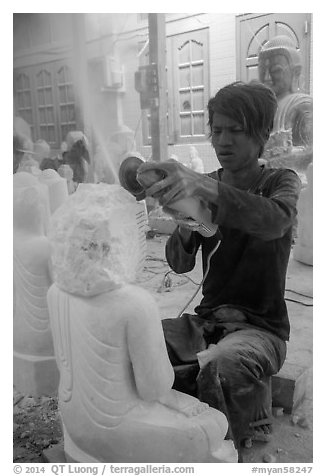 Man carving marble buddha statue with grinder. Mandalay, Myanmar (black and white)