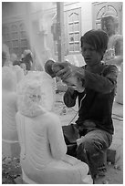 Man carving marble buddha statue with grinder. Mandalay, Myanmar ( black and white)