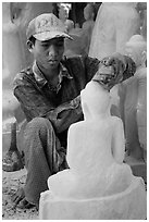 Sculptor carving buddha statue out of a block of white marble. Mandalay, Myanmar ( black and white)