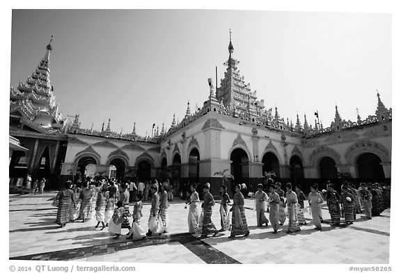 Novices and families walk in procession during Shinbyu ceremony, Mahamuni Pagoda. Mandalay, Myanmar (black and white)