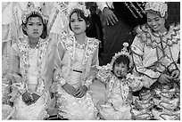 Girls with make-up and princely attire reacting during Noviciation, Mahamuni Pagoda. Mandalay, Myanmar ( black and white)