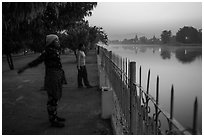 Women exercising next to Mandalay Fort at dawn. Mandalay, Myanmar ( black and white)