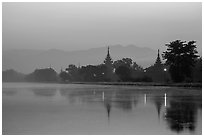 Pagodas reflected in moat at dawn, Mandalay Fort. Mandalay, Myanmar ( black and white)