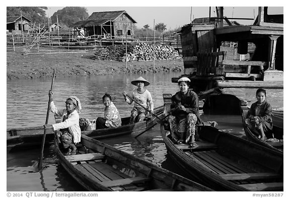 Row boats and huts on shore of Irrawaddy River. Mandalay, Myanmar (black and white)